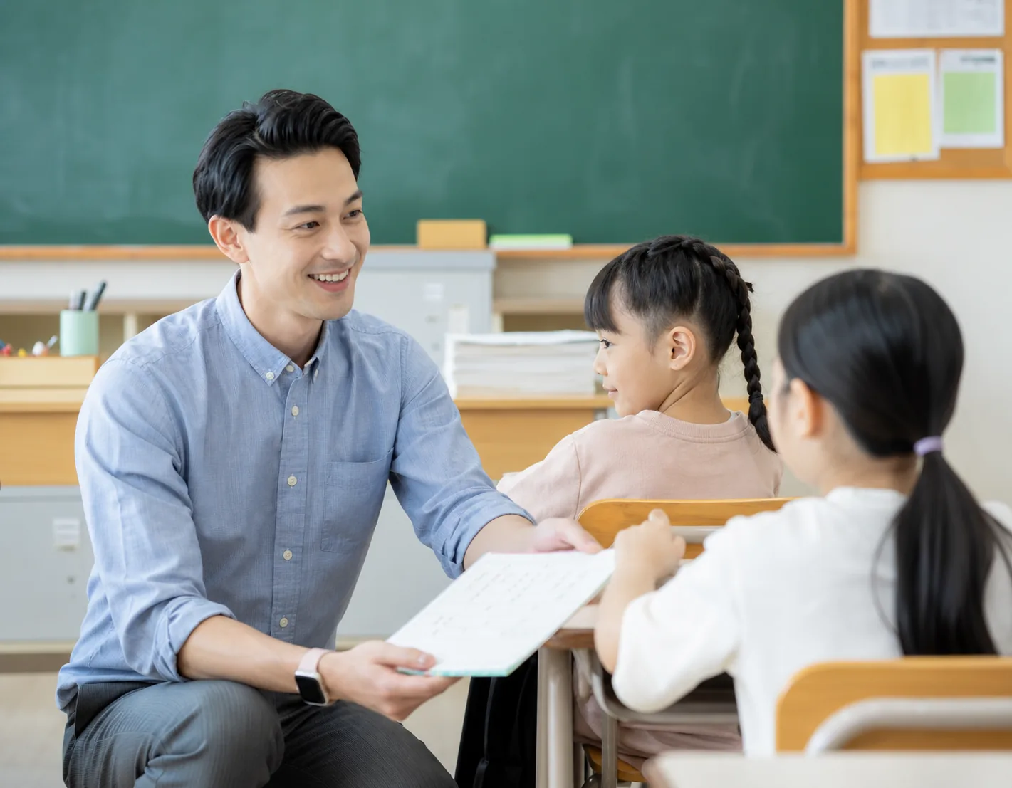 教室で先生から子どもへ応援ノートが手渡される様子
